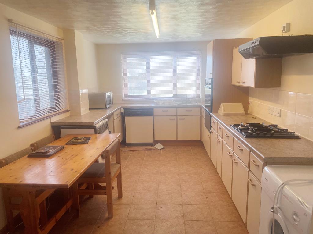 Lot: 38 - FREEHOLD PROPERTY WITH ADDITIONAL LAND - Kitchen with fitted units and table